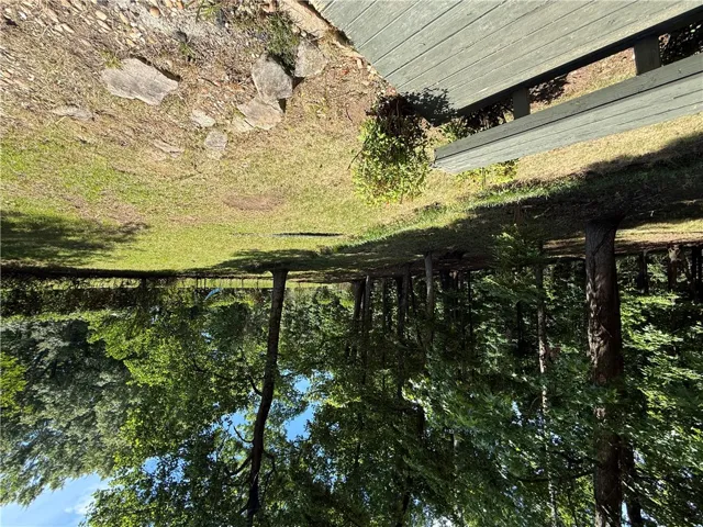 This verdant yard offers expansive green space, perfect for outdoor enjoyment and relaxation.