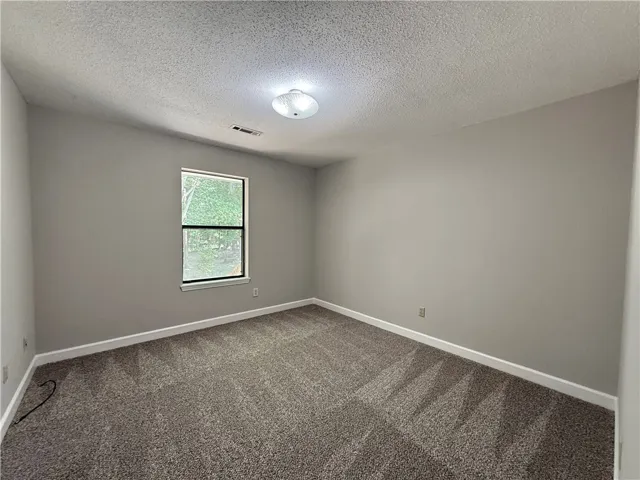 This spacious bedroom offers a neutral canvas, ready for your personalized touch.