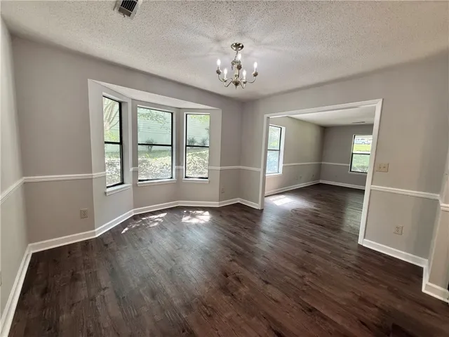 This inviting space features bay windows, hardwood flooring, and an open layout, perfect for daily living.