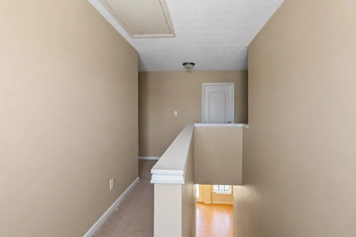 This interior hallway offers convenient access to various areas of the home.
