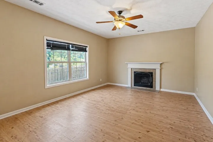 This living area features a warm fireplace and ample natural light from the large window.