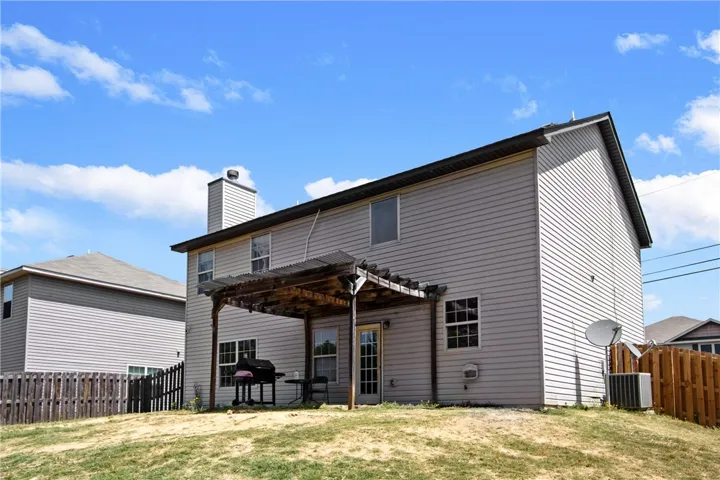 This residence features a charming pergola, perfect for outdoor entertaining and relaxation.