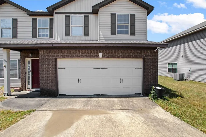 This charming home offers a convenient attached garage and a welcoming facade.