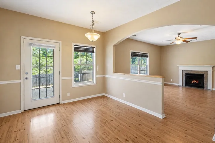 This versatile space offers warm wood flooring and abundant natural light for comfortable living.
