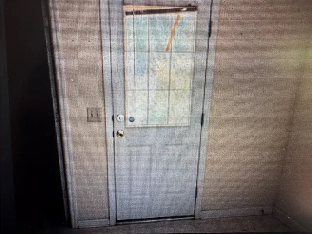 This entry door with a decorative window panel offers a classic aesthetic.