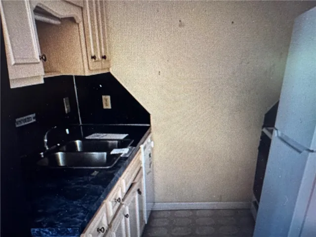 This compact kitchen offers functional space with essential amenities for daily living.