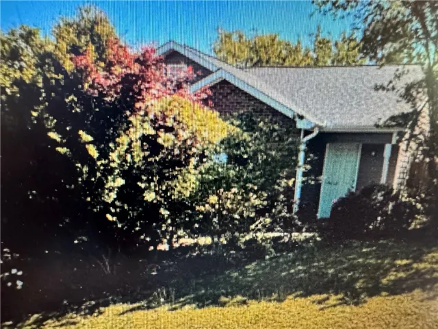 This charming home offers a serene escape, surrounded by mature trees.