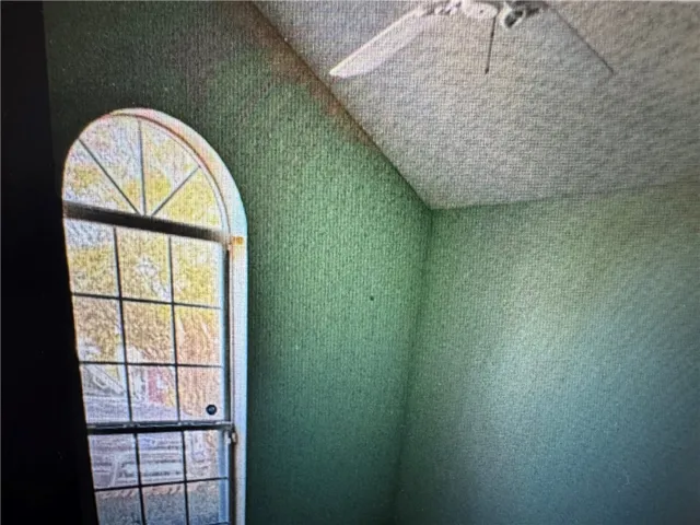 This interior space features a distinctive arched window, offering unique architectural appeal.