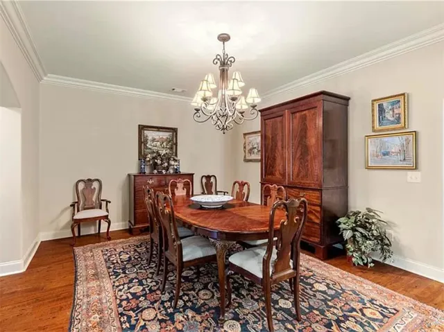 This elegant dining room features hardwood floors and crown molding, perfect for entertaining.