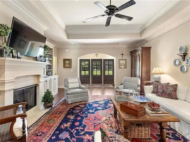 This inviting living space features warm hardwood floors and a cozy fireplace.
