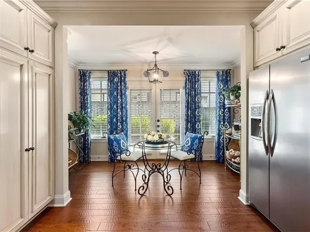 This inviting breakfast nook features rich hardwood flooring and convenient access to the outdoors.
