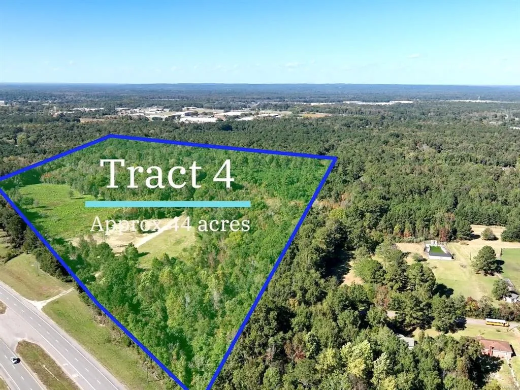 This aerial view showcases a expansive lot with abundant greenery and natural surroundings.