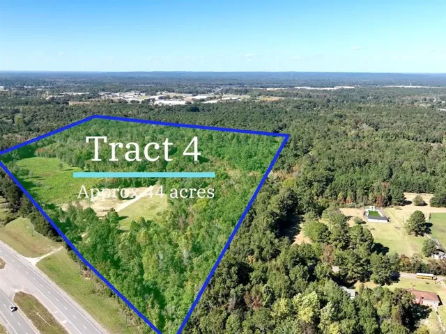 This aerial view showcases a expansive lot with abundant greenery and natural surroundings.
