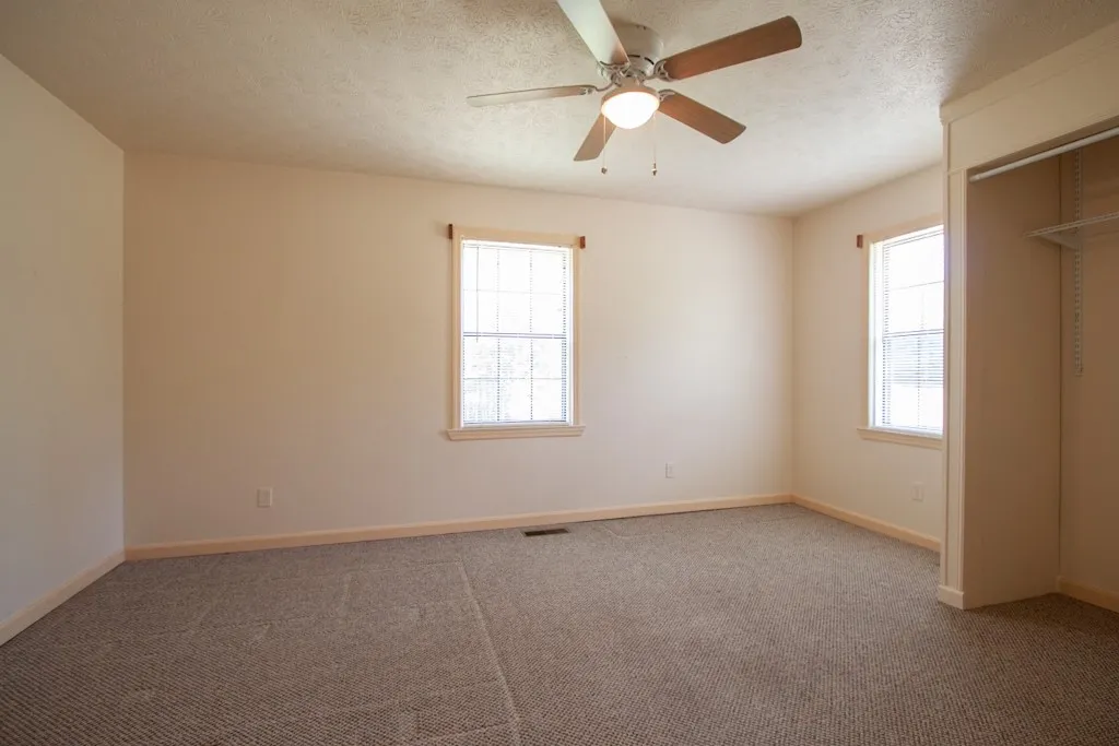 Bedroom 3 has ample natural light and carpet.