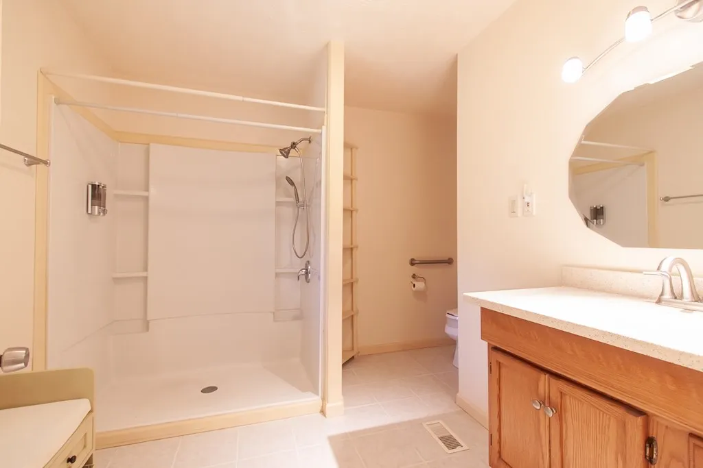 The en-suite bathroom has a spacious shower.
