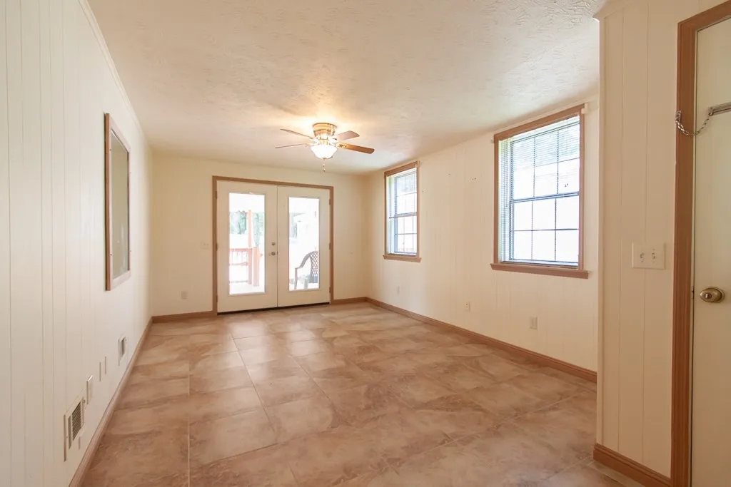 This bright and airy flex room adjacent to the covered deck offers abundant natural light and versatile living space.