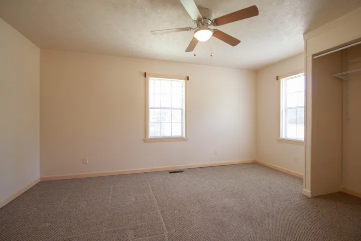 Bedroom 3 has ample natural light and carpet.