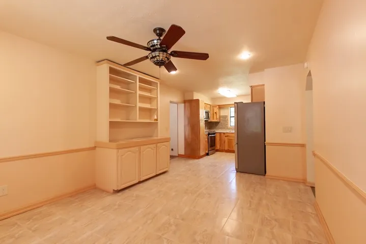 This Breakfast/Dining Room features an open layout connecting to a functional kitchen.