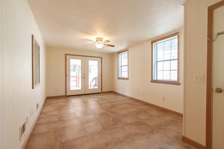 This bright and airy flex room adjacent to the covered deck offers abundant natural light and versatile living space.