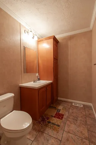 Mobile home 1/2 bath conveniently located between the living room and flex room.
