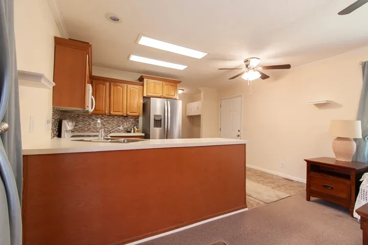 The mobile home kitchen area features practical amenities and comfortable living.