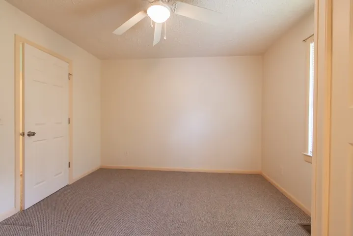 This cozy bedroom offers a tranquil retreat with carpet, natural light and en-suite bath.