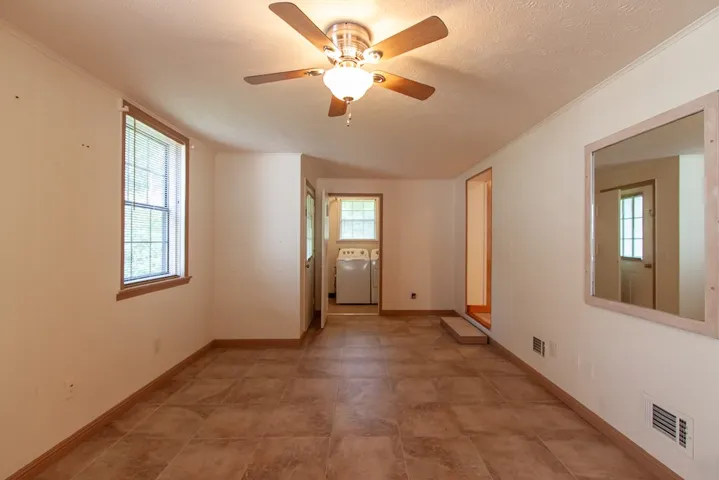 This flex space offers convenient laundry amenities and ample room for daily tasks.