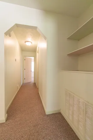 Hallway leading to Bathroom 2 and Bedroom 3.