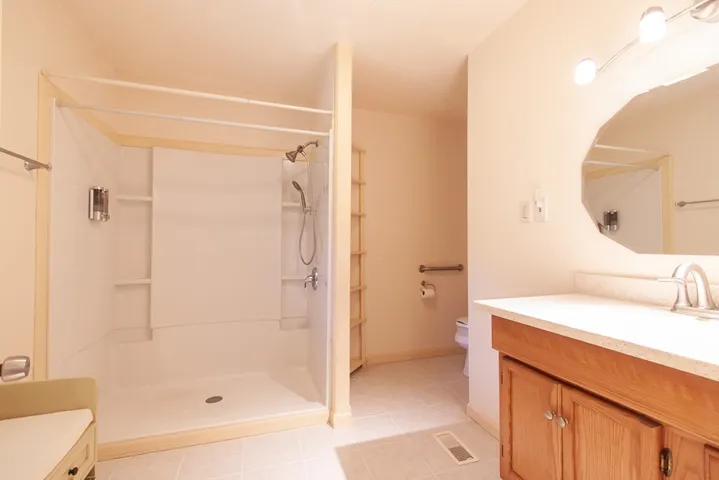 The en-suite bathroom features a spacious shower.