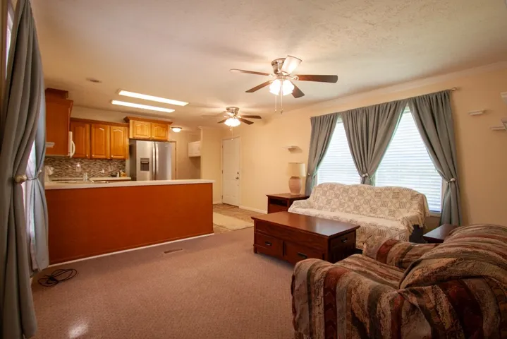 Bright and open living space connects seamlessly to the kitchen, perfect for daily living .