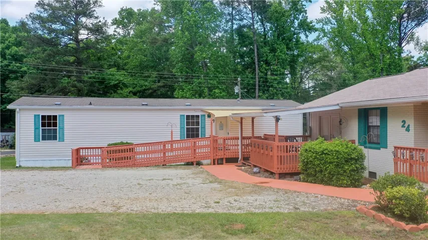 This residence features convenient access with a ramp leading to the mobile home and covered deck of the home.