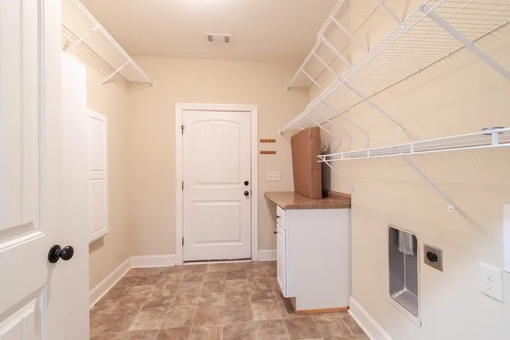 Functional laundry room has ample storage and easy garage access.