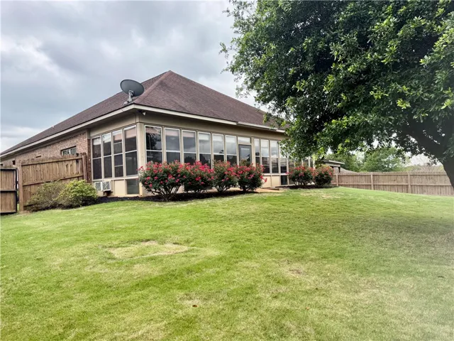 This spacious backyard with mature trees offers a private oasis for outdoor enjoyment.
