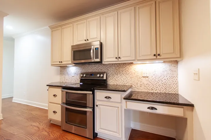 There are stainless appliances, under cabinet lighting and a built in desk. Get your cookbooks ready.
