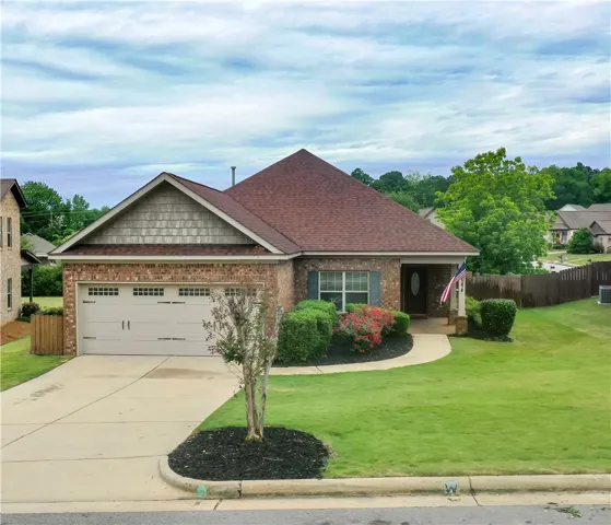 There is a well-maintained lawn and mature landscaping.