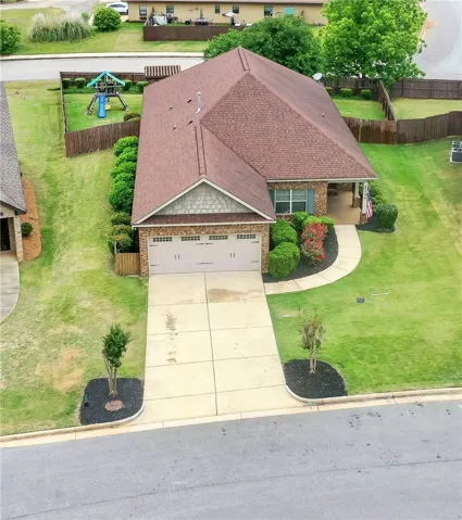 This charming home offers a spacious fenced yard and a welcoming front porch.