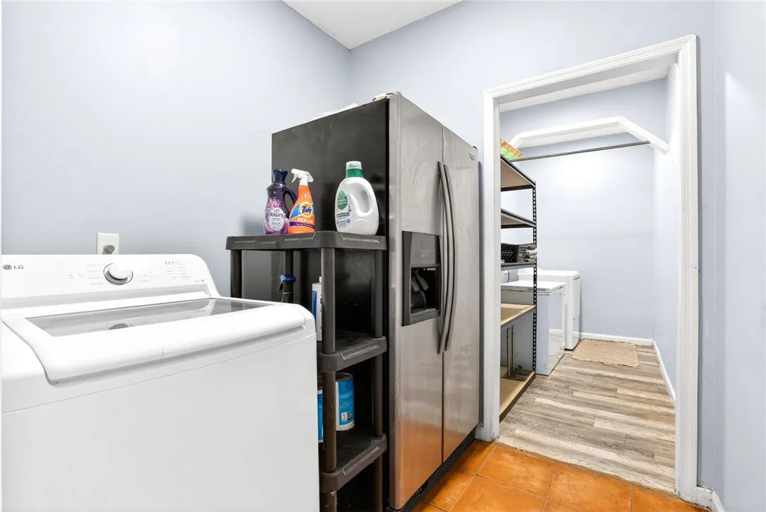 This dedicated laundry space offers convenience with ample room for household chores.