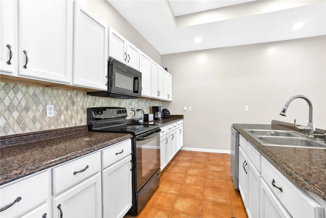 This bright kitchen features ample cabinetry and durable countertops, perfect for daily living.