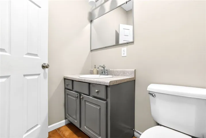 This clean bathroom features a sleek vanity, complementing the modern aesthetic.