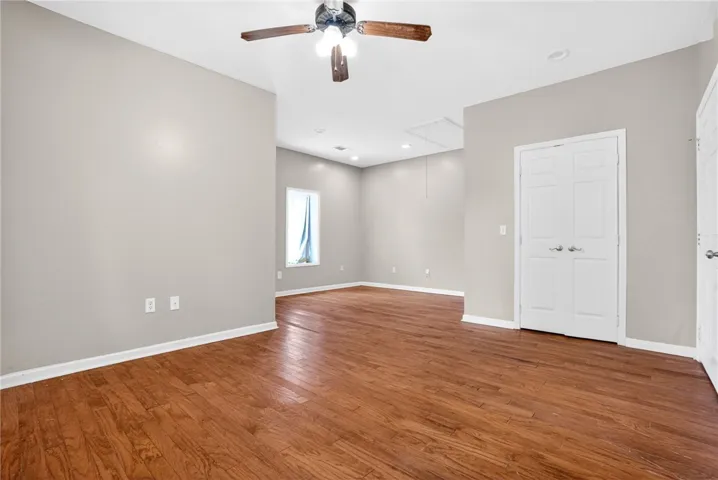 This expansive room features beautiful hardwood floors and a convenient ceiling fan.
