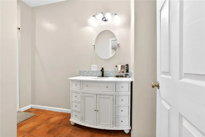 A well-appointed bathroom with classic tile flooring and a refined vanity.