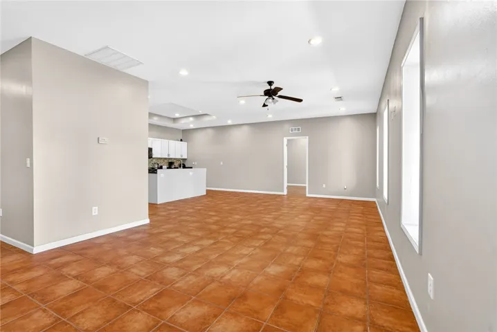 This expansive interior space features durable tile flooring, creating a seamless flow throughout.