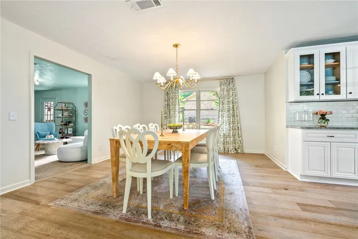 This bright dining room features rich wood flooring and abundant natural light.