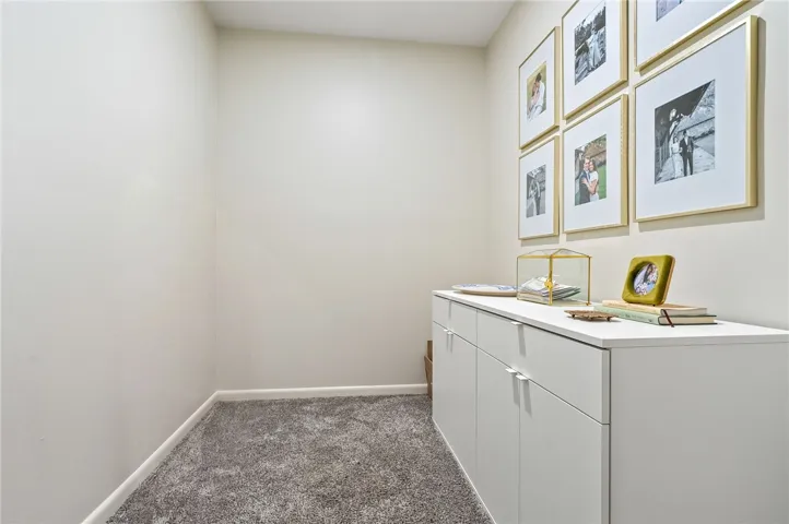 This versatile interior space features soft carpeting, offering comfort and style.