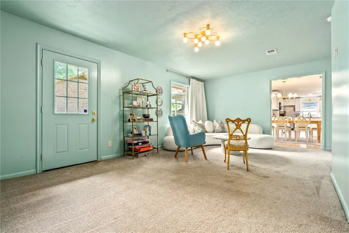 This inviting living area features plush carpeting and an open flow to the kitchen.