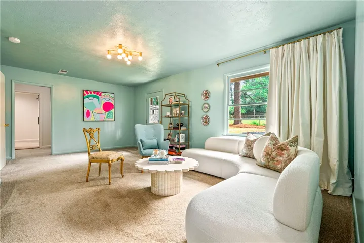 Bright and airy living room with ample natural light, perfect for relaxation and gatherings.