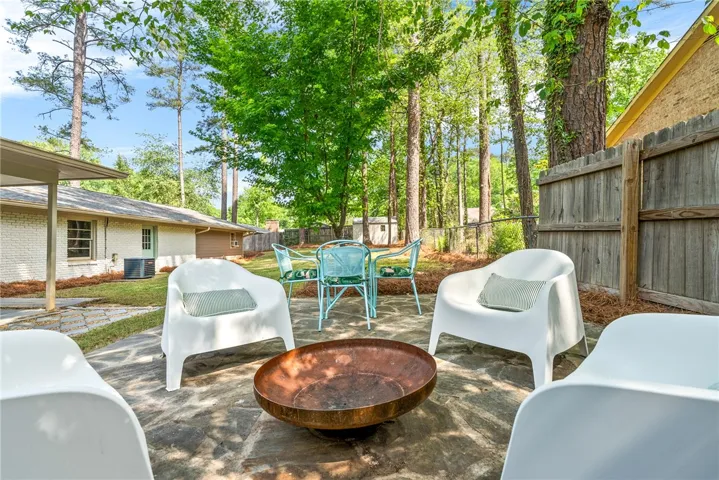 This tranquil patio features a fire pit, ideal for cozy evenings.