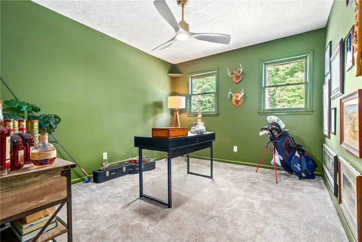 This versatile room offers a comfortable atmosphere for work or leisure with ample natural light.