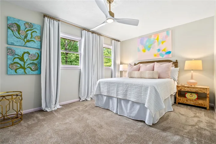 This cozy bedroom features ample natural light and a comforting atmosphere.
