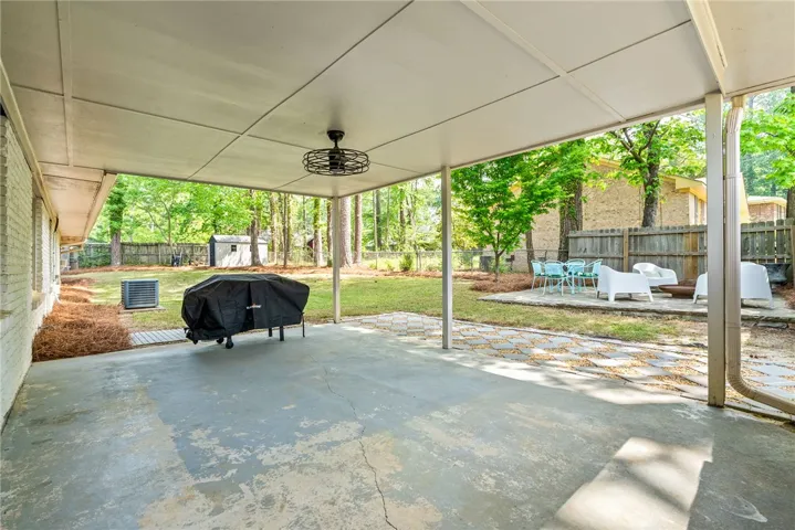 Enjoy outdoor living on this expansive covered patio, perfect for relaxation and entertaining.